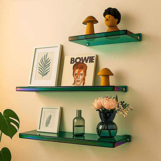 Decorative shelves with books, a vase, and small figurines against a beige wall.