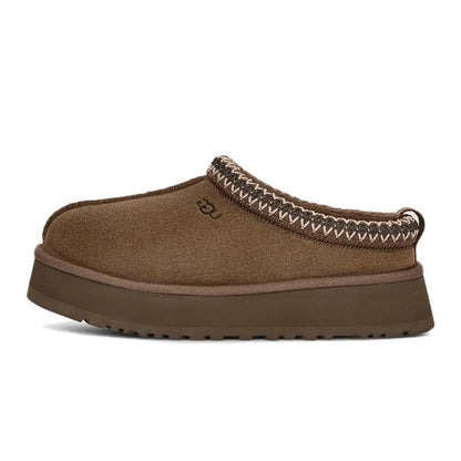 Brown slipper with textured trim on a white background