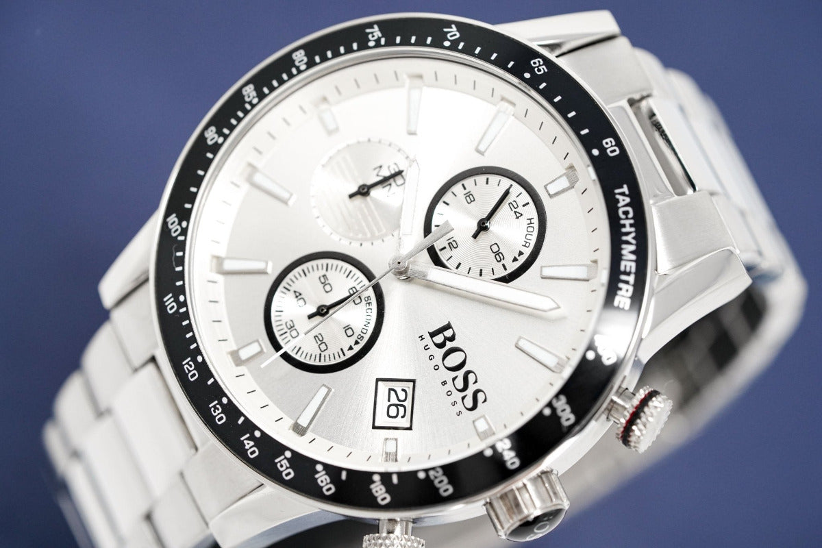 Silver watch with a white face and black details on a blue background