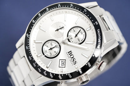 Silver watch with a white face and black details on a blue background