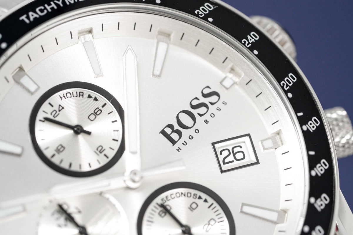 Close-up of a Hugo Boss watch with a white face and black bezel.