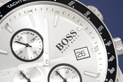 Close-up of a Hugo Boss watch with a white face and black bezel.